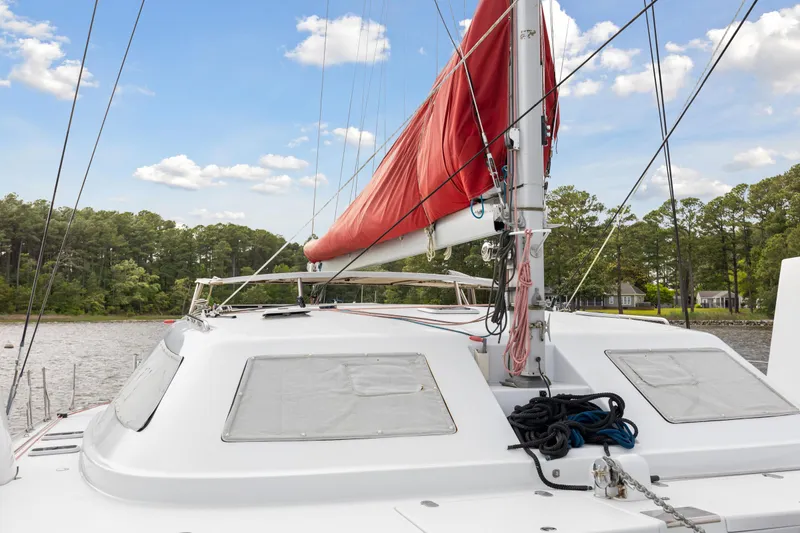 Slide: The Image of Sailboat Switch 55 (2006) with red sail on a calm river. - 29