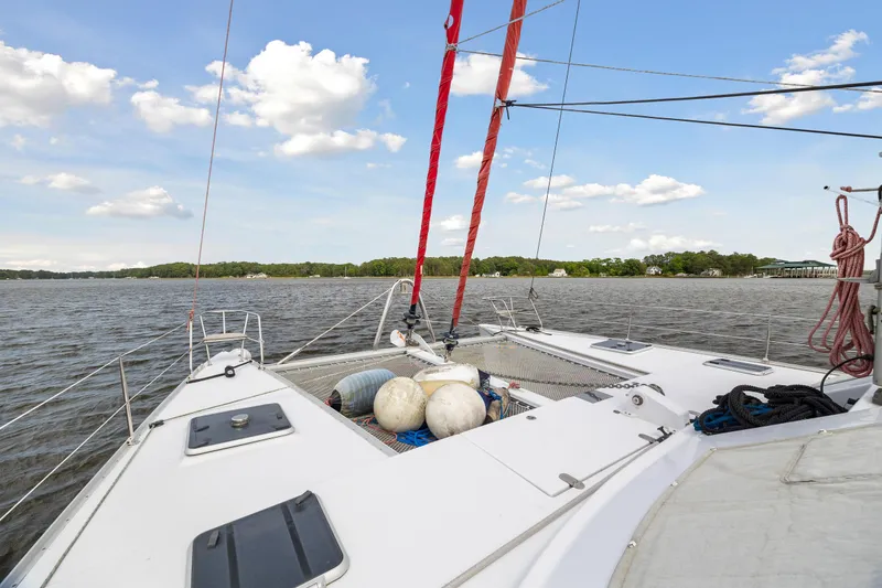Slide: The Image of Sailing on a 2006 Switch 55 catamaran with red ropes and scenic lake view. - 31