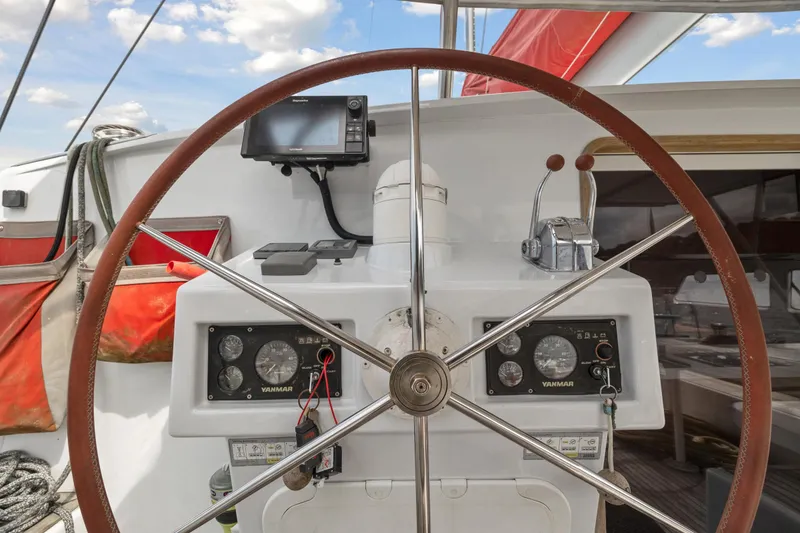 Slide: The Image of Steering wheel and control panel of a 2006 Switch 55 sailboat. - 43