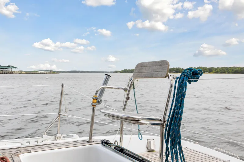 Slide: The Image of Sailboat deck with chair and ropes, Switch 55 model, 2006, on a calm lake. - 45
