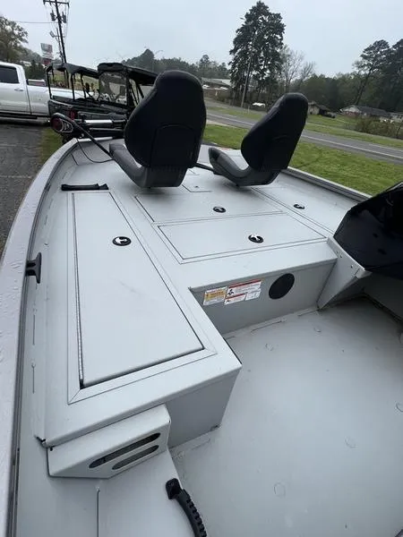 Slide: The Image of 2023 Crestliner XFC 179 boat interior with dual seats and storage compartments. - 1