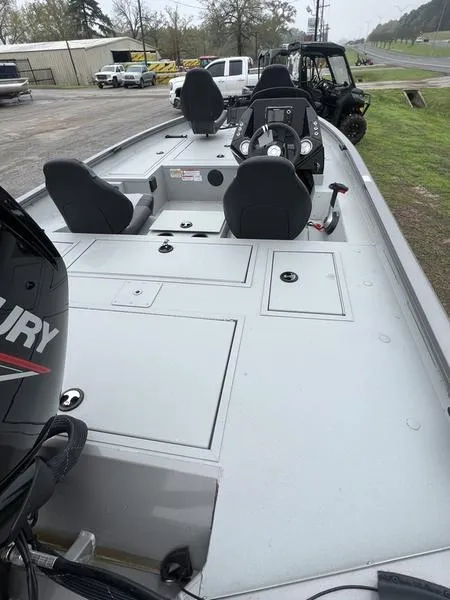 Slide: The Image of 2023 Crestliner XFC 179 boat with Mercury engine, spacious deck, and seating. - 6