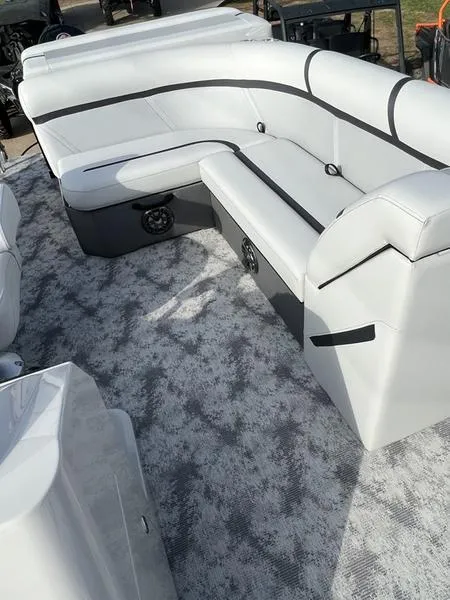 Slide: The Image of 2023 Crest Classic LX 200 L boat interior with plush white seating and modern design. - 4