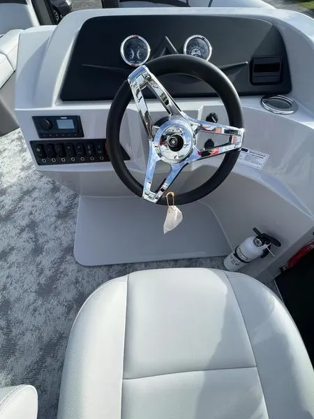Slide: The Image of 2023 Crest Classic LX 200 L boat steering console with modern controls and sleek design. - 5