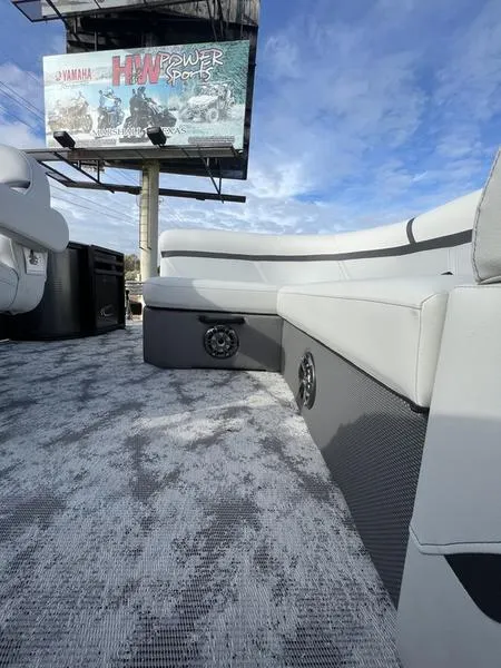 Slide: The Image of 2023 Crest Classic LX 200 L pontoon boat interior with gray seating and flooring. - 6