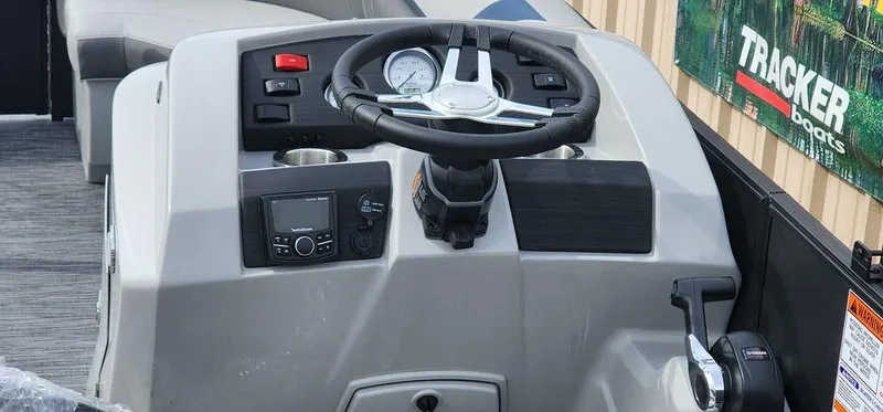 Slide: The Image of 2023 Bennington 23 SXSR boat dashboard with steering wheel and controls. - 13