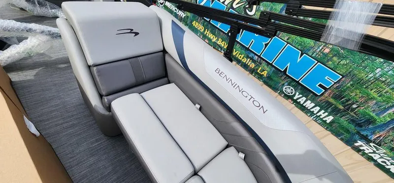 Slide: The Image of 2023 Bennington 23 SXSR boat interior with gray seating and branding. - 16