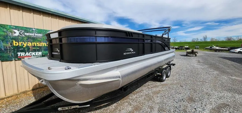 Slide: The Image of 2023 Bennington 23 SXSR pontoon boat on trailer, parked outdoors. - 19