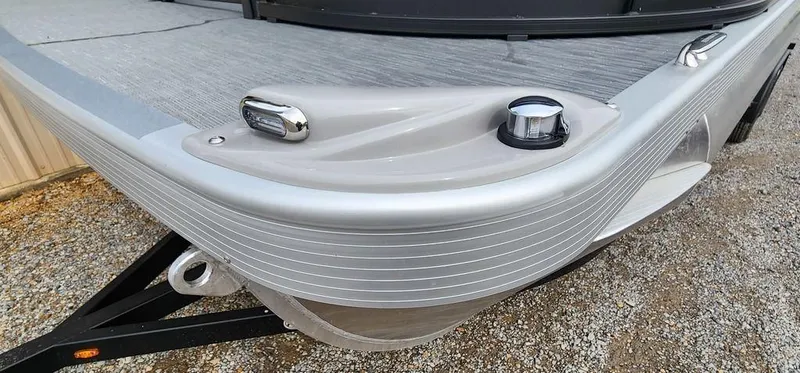 Slide: The Image of 2023 Bennington 23 SXSR boat, sleek design, silver finish, dock cleat, and navigation light. - 4