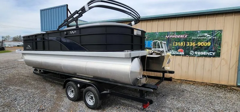 Slide: The Image of 2023 Bennington 23 SXSR pontoon boat on trailer, parked outside dealership. - 8