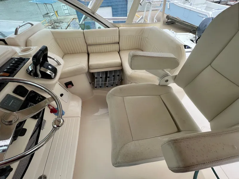 Slide: The Image of 2007 Grady-White Express 360 boat interior with beige seating and steering wheel. - 10