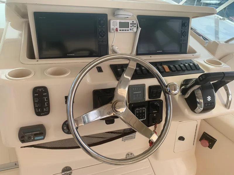 Slide: The Image of 2007 Grady-White Express 360 helm with dual screens and steering wheel. - 11