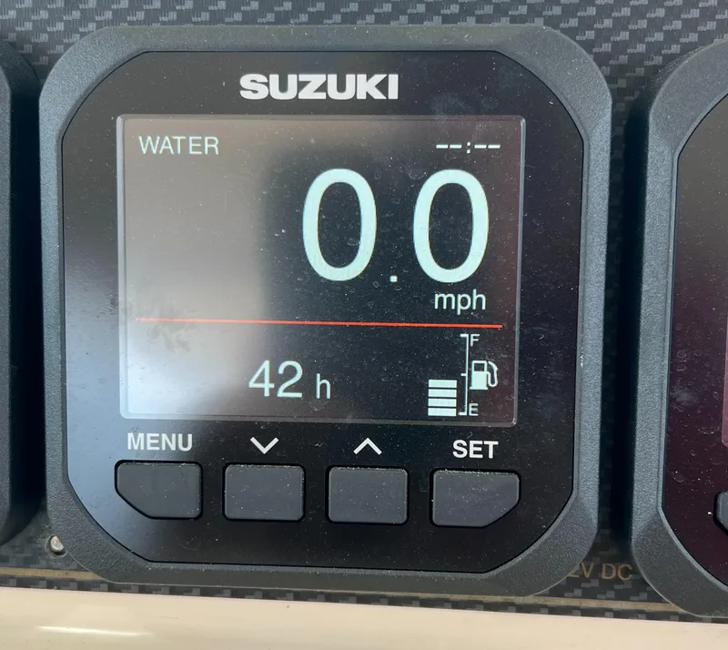 Slide: The Image of Suzuki digital display showing 0.0 mph speed and 42 hours on Grady-White Express 360. - 16