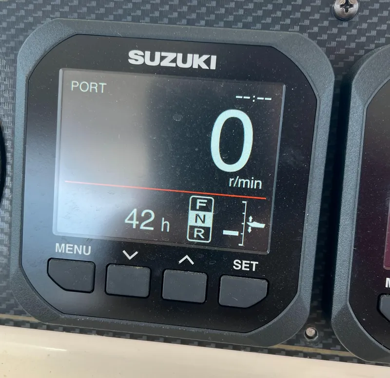 Slide: The Image of Suzuki engine display showing 0 RPM and 42 hours on Grady-White Express 360, 2007. - 17