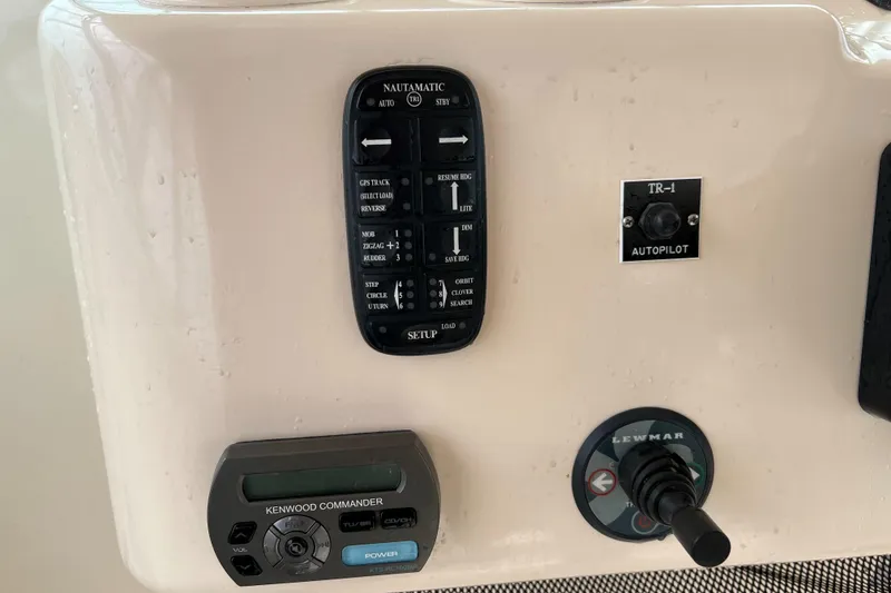 Slide: The Image of Control panel of a 2007 Grady-White Express 360 boat with autopilot and Kenwood Commander. - 18