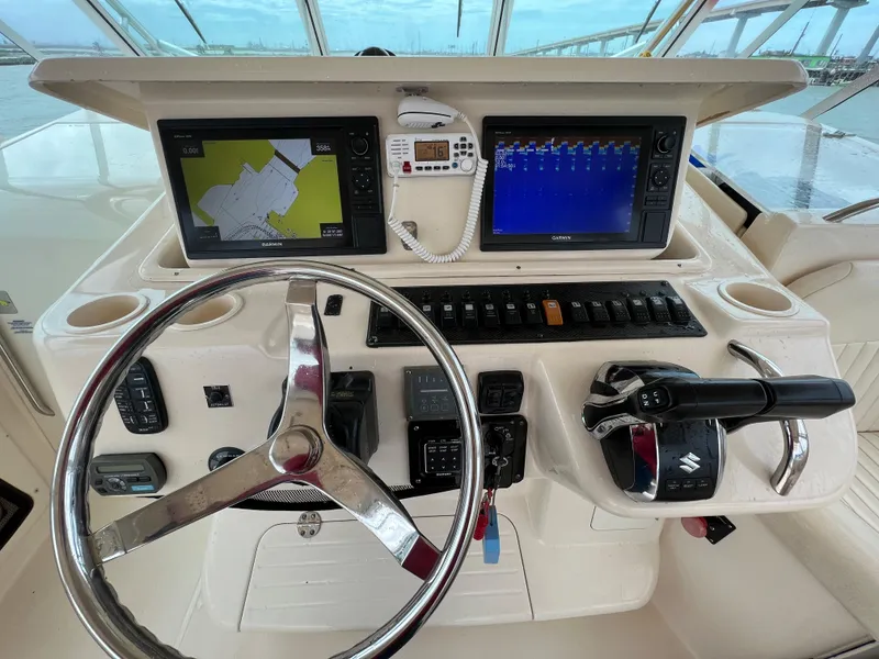 Slide: The Image of 2007 Grady-White Express 360 helm with dual navigation screens and steering wheel. - 2