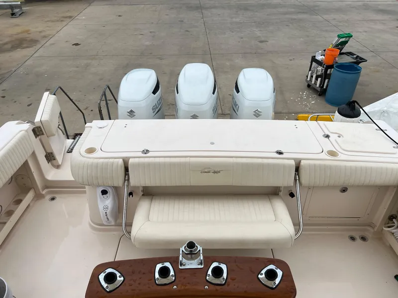 Slide: The Image of 2007 Grady-White Express 360 boat with triple outboard engines, docked on concrete surface. - 22