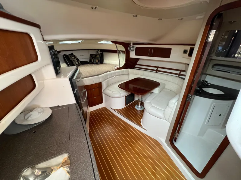 Slide: The Image of Luxurious 2007 Grady-White Express 360 yacht interior with wood flooring and plush seating. - 29