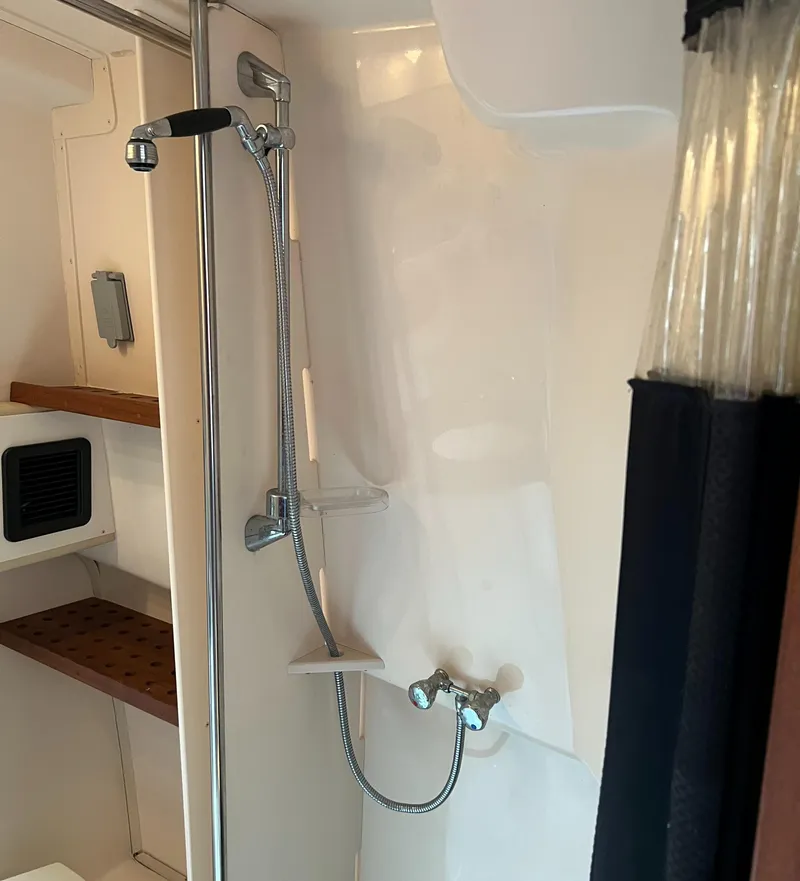 Slide: The Image of Shower area in 2007 Grady-White Express 360 boat, featuring modern fixtures and shelving. - 36