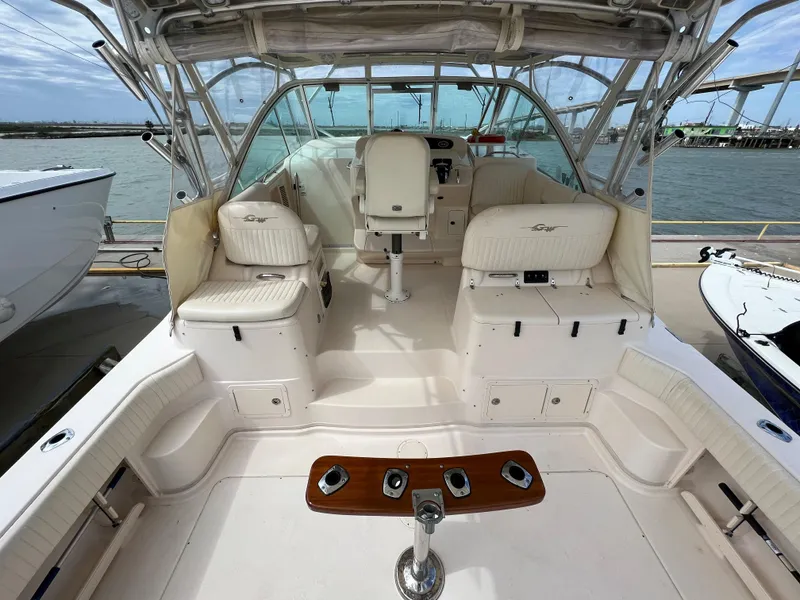 Slide: The Image of 2007 Grady-White Express 360 boat interior with seating and helm, docked by the water. - 4