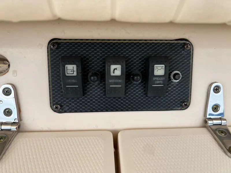 Slide: The Image of Control panel on a 2007 Grady-White Express 360 boat with three switches. - 45