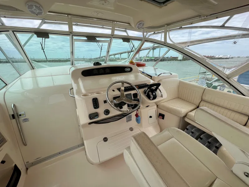 Slide: The Image of 2007 Grady-White Express 360 helm with steering wheel, controls, and seating, overlooking marina. - 9