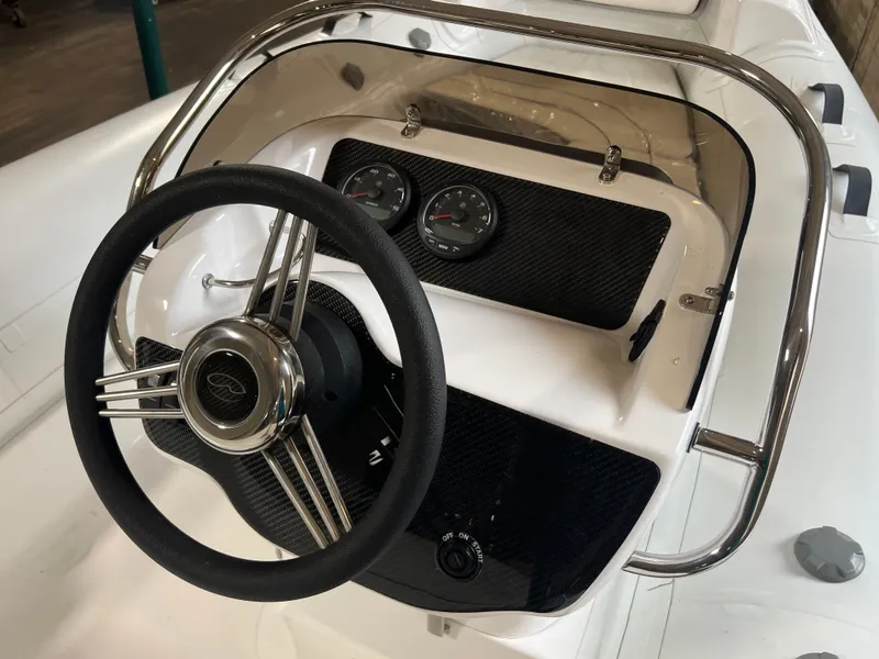 Slide: The Image of 2023 Walker Bay Generation 450 boat dashboard with steering wheel and gauges. - 1