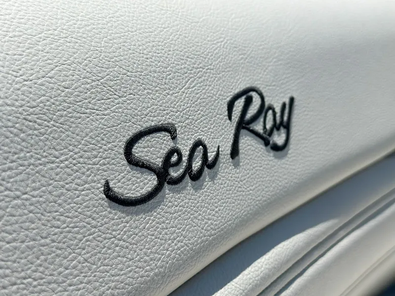 Slide: The Image of Close-up of 2023 Sea Ray SLX 260 Outboard logo on white leather upholstery. - 12