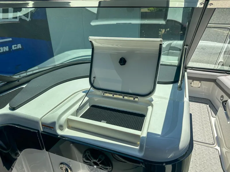 Slide: The Image of 2023 Sea Ray SLX 260 Outboard boat interior with open storage compartment. - 17