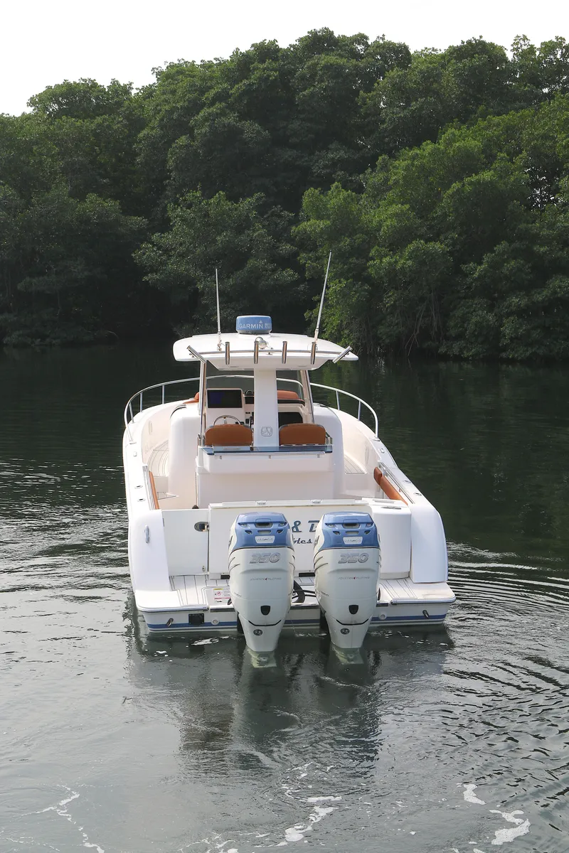 Slide: The Image of 2018 Belzona 327wa boat with dual engines cruising on a calm waterway. - 13