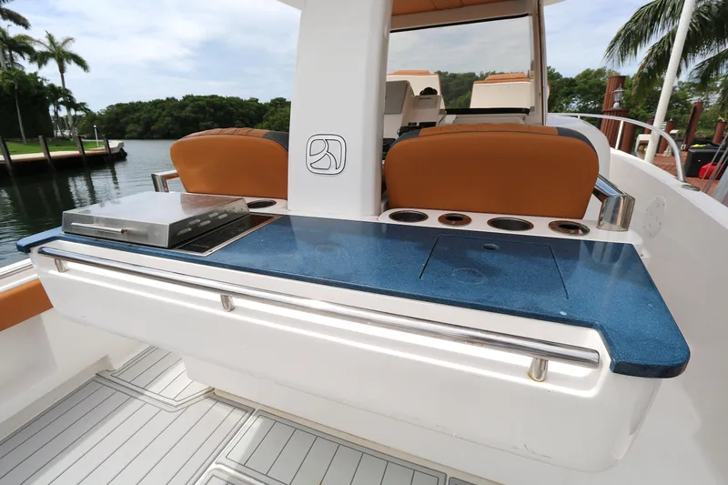 Slide: The Image of 2018 Belzona 327wa boat interior with sleek blue countertop and seating. - 3