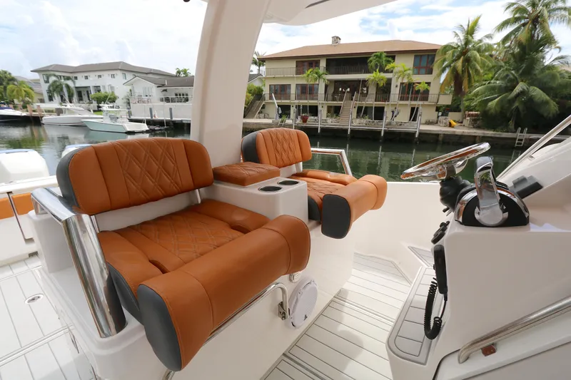 Slide: The Image of Luxurious seating on a 2018 Belzona 327wa boat, docked near waterfront homes. - 5