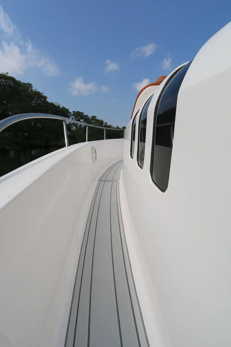 Slide: The Image of 2018 Belzona 327wa boat deck with sleek design and clear blue sky. - 6