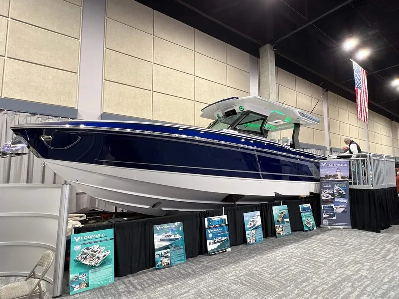 Slide: The Image of 2023 Formula 387 Center Console Sport boat displayed at an indoor exhibition. - 2