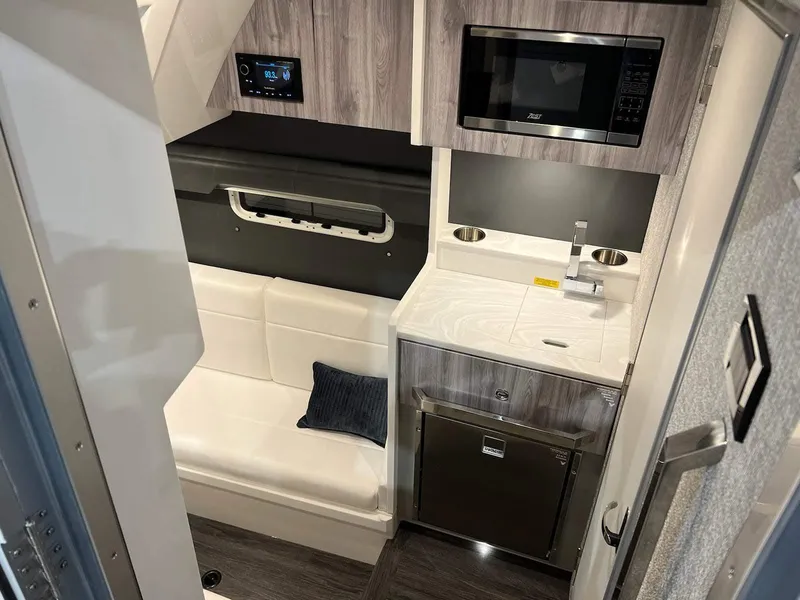 Slide: The Image of 2023 Formula 387 Center Console Sport interior with seating, kitchenette, and modern amenities. - 8