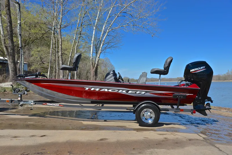 Slide: The Image of 2021 Tracker 175 TXW fishing boat with Mercury engine on a trailer by a lake. - 11