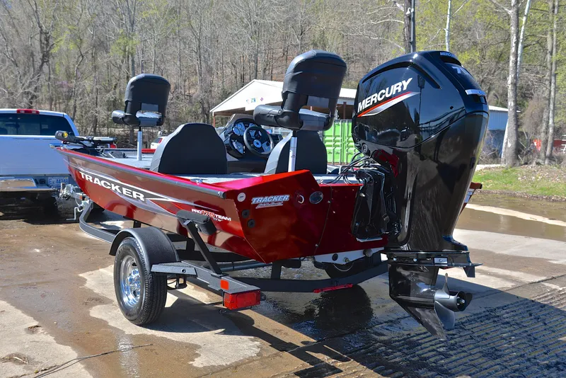 Slide: The Image of 2021 Tracker 175 TXW boat with Mercury engine on trailer, parked outdoors. - 12