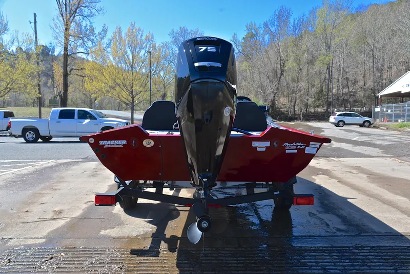 Slide: The Image of 2021 Tracker 175 TXW boat with outboard motor on a trailer in a parking lot. - 13