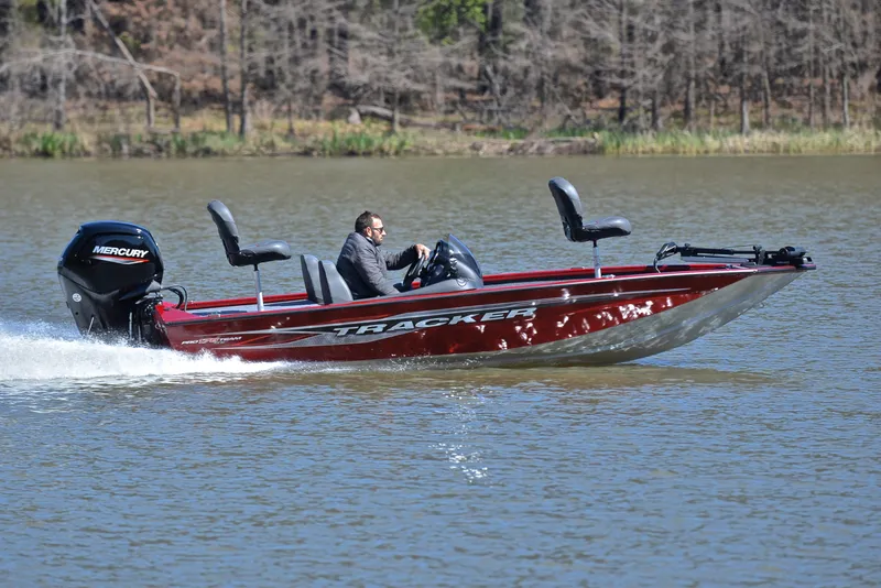 Slide: The Image of 2021 Tracker 175 TXW boat speeding on a lake with Mercury engine. - 3