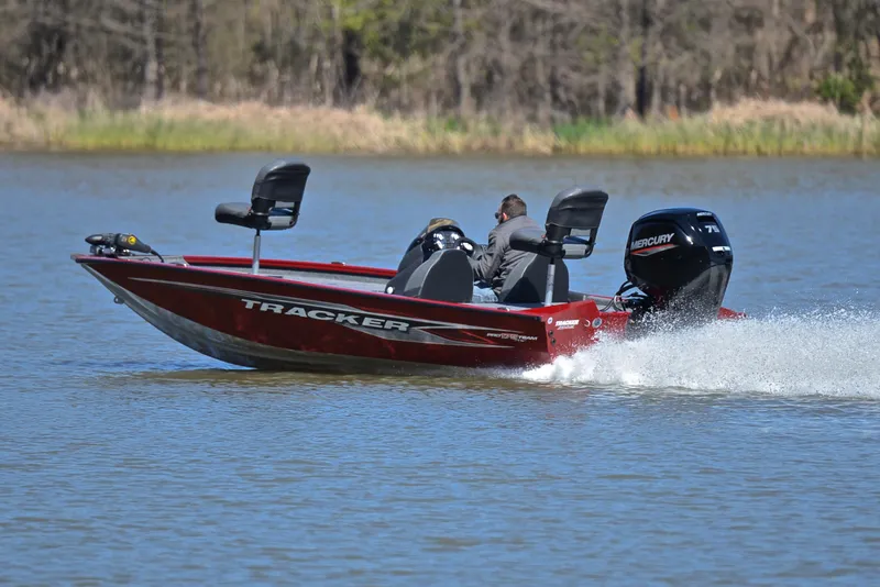Slide: The Image of 2021 Tracker 175 TXW boat speeding on a lake with two passengers. - 4