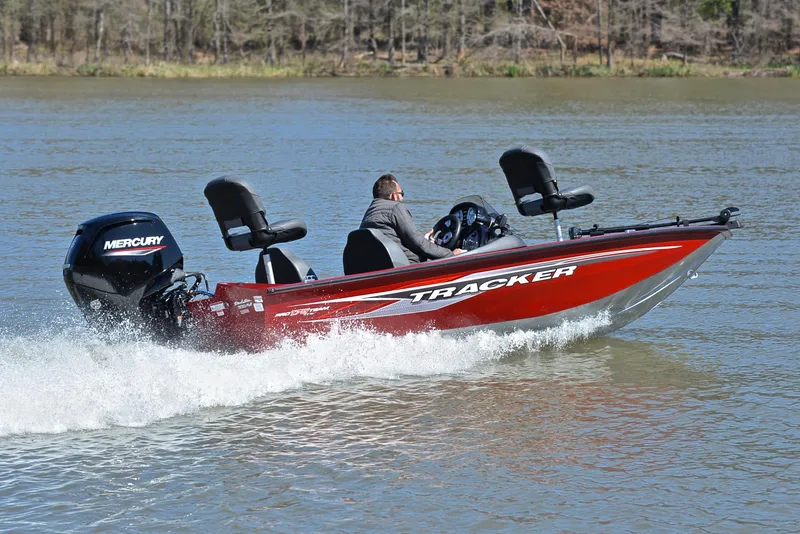 Slide: The Image of 2021 Tracker 175 TXW boat cruising on a lake with Mercury engine. - 5