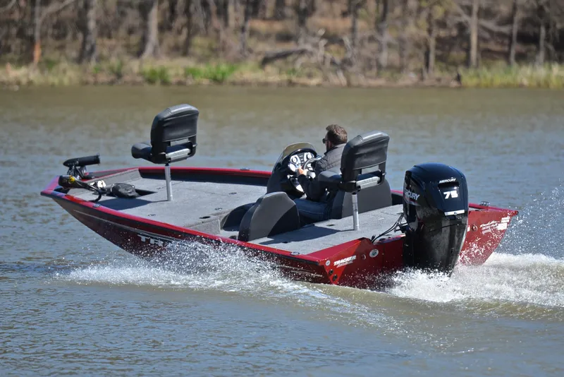 Slide: The Image of 2021 Tracker 175 TXW boat cruising on a lake with a person steering. - 6
