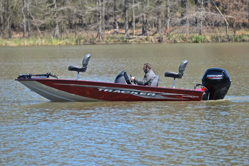 Slide: The Image of 2021 Tracker 175 TXW boat on a lake with a Mercury engine. - 9