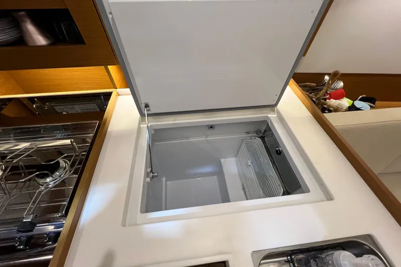 Slide: The Image of 2023 Jeanneau Sun Odyssey 380 yacht kitchen with open fridge and stove. - 16
