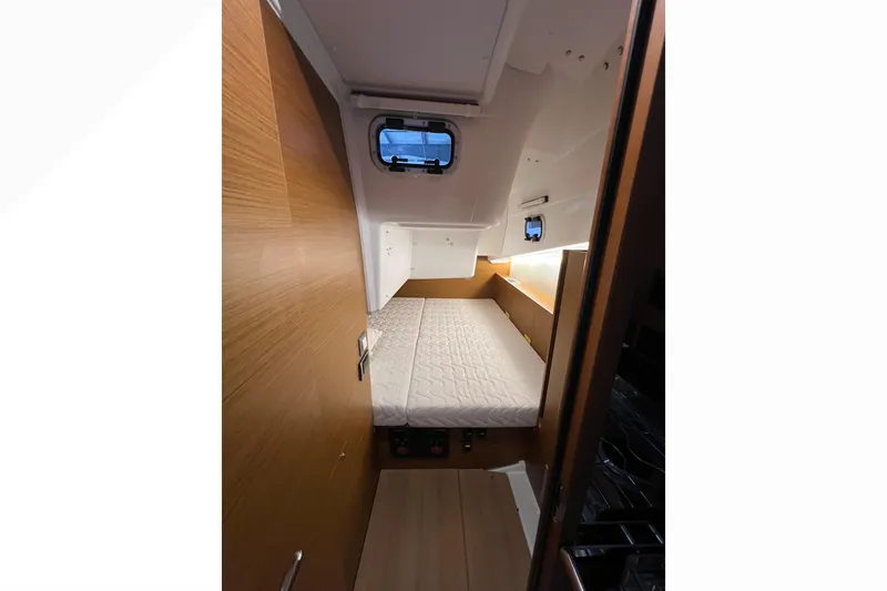 Slide: The Image of 2023 Jeanneau Sun Odyssey 380 cabin interior with bed and wooden finish. - 18