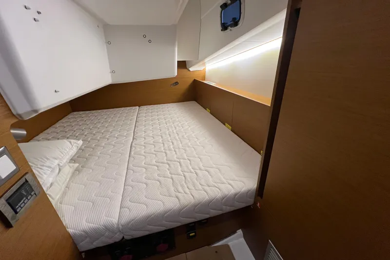 Slide: The Image of Cozy cabin interior of 2023 Jeanneau Sun Odyssey 380 sailboat with comfortable bedding. - 20