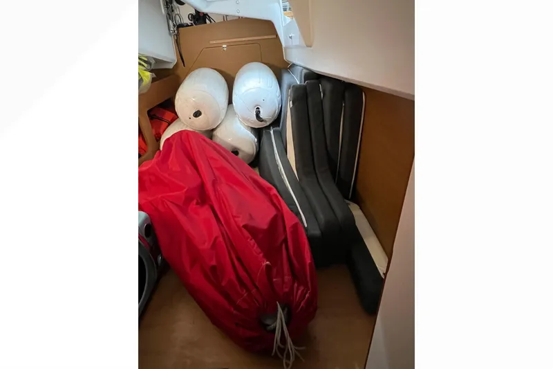 Slide: The Image of Storage area in 2023 Jeanneau Sun Odyssey 380 with fenders and red cover. - 21