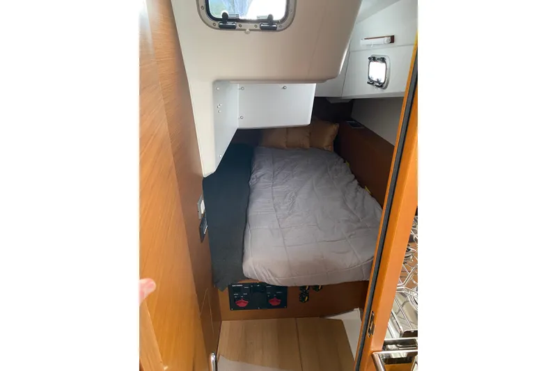 Slide: The Image of Cozy cabin interior of 2023 Jeanneau Sun Odyssey 380 sailboat with bed and porthole. - 22
