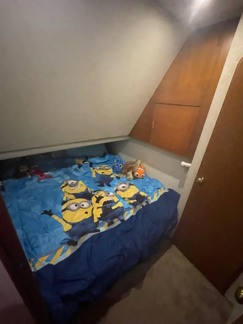 Slide: The Image of Small bedroom in 2000 Ocean Yachts Convertible with Minions-themed bedding. - 11