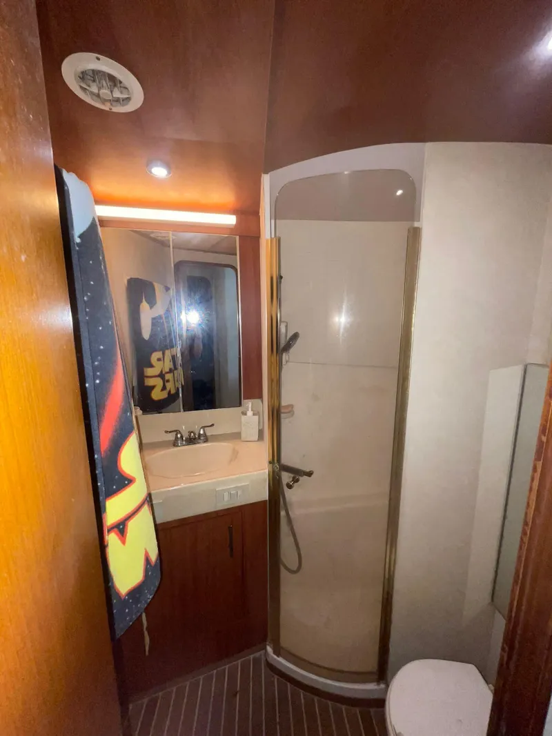 Slide: The Image of Bathroom interior of 2000 Ocean Yachts Convertible with shower and sink. - 12